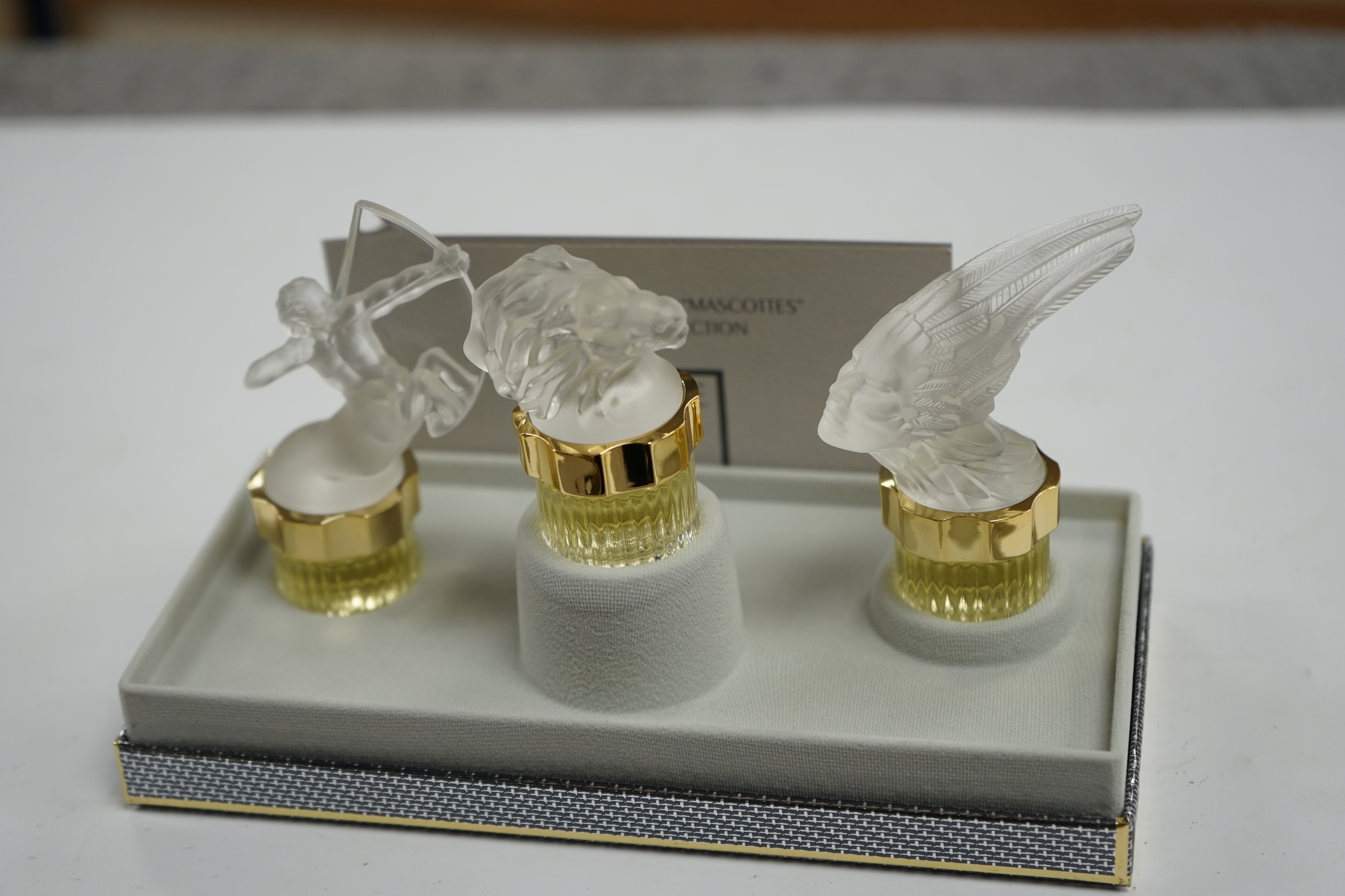 Two boxed Lalique sets, Flacons collection, Les Mascottes, tallest 7cm high. Condition - good